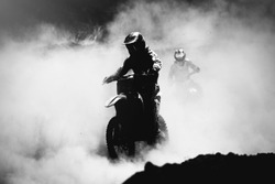 Motocross racer accelerating in dust track, Black and white, high contrast photo
