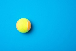 Beach tennis ball on blue background. Horizontal education and sport poster, greeting cards, headers, website