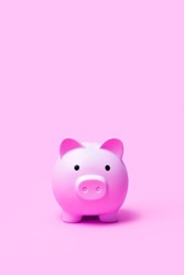Pink color piggy bank on pink color background