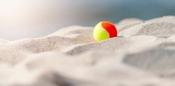 Beach tennis ball on the sandy beach. Summer sport concept. Horizontal sport theme poster, greeting cards, headers, website and app