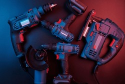 Set of new power tools isolated on a black background, drill, puncher, electric saw, jigsaw, circular saw
