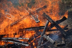 Ancient traditions of burning bonfires in cemeteries, when old crosses were burned and dead relatives were remembered. Cemetery maintenance workers burn old crosses