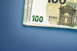 100 euro banknotes on blue background. Pack of money
