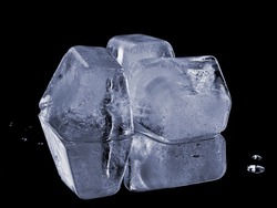 natural ice cubes, isolated on black background with reflection