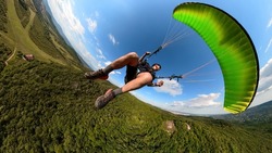 Man flying the paragliding alone at sunny day, adventure concept