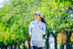 Jogging and Japanese adult woman, green nature background