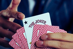 Businessman holding a Playing card