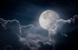 Attractive photo of a nighttime sky with clouds, bright full moon would make a great background. Nightly sky with large moon. Beautiful nature use as background. Outdoors.