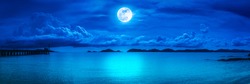 Beautiful panorama view of the sea. Colorful blue sky with cloud and bright full moon on seascape to night. Serenity nature background, outdoor at nighttime. The moon taken with my own camera.