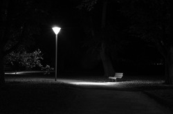 A lonely park bench at night.