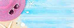 Colorful summer holiday beach banner background with accessories on light blue wood panel, border design on top view with copy space
