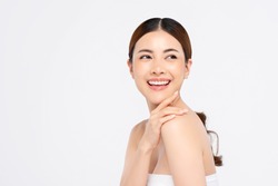 Youthful smiling Asian woman with hand touching face isolated on white background for beauty and skin care concepts