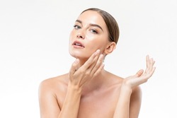 Fresh and clean skin woman touching her face in white isolated studio background for beauty and skincare concepts