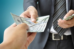 Hand receiving money from businessman - United States dollar (USD) bills