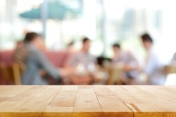 Wood table top with blurred people in cafe as background - can be used for montage or display your products