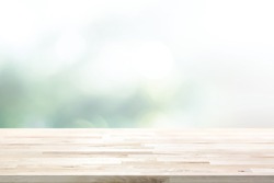 Wood table top on  blur abstract white green bokeh background - can be used for display products (or food)