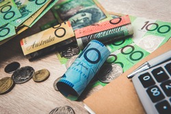 Money, Australian dollars (AUD), with notebook and calculator on the table - financial and investment concepts