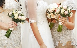 Bride wearing gorgeous wedding dress, with bridesmaids posing. 