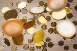 Business background with Euro coins falling from above