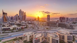 Sunset over Dubai Media City with Modern buildings aerial timelapse, United Arab Emirates. Dubai marina on a background with traffic on a road