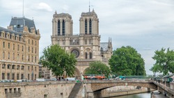 Notre Dame de Paris and Seine timelapse is the one of the most famous symbols of Paris. Petit Bridge - Cardinal Lustiger. View from Bridge of Saint-Michel with boats on river at sunny summer day