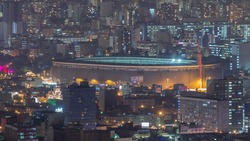 Aerial view of the National stadium in the Peruvian capital Lima from San Cristobal hill night timelapse. Landscape of slum urban area and historic buildings in South America. Peru
