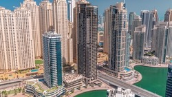 Jumeirah Beach Residence and original architecture yellow towers in Dubai aerial timelapse. Residential area on a seaside near Dubai marina with construction site