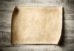antique blank parchment on aged wooden wall