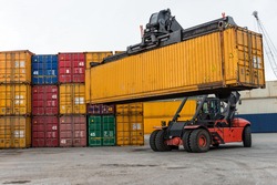 Mobile stacker handler in action at a container terminal.