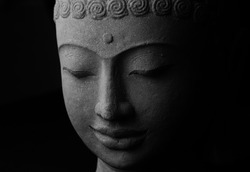 Black and white top view closeup picture of Buddha statue. Buddha's face