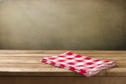 Background with tablecloth and wooden deck table over grunge background