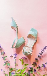 Fashion - summer footwear for woman. Pastel mint green sandals shoes and meadow flowers on bright pink background. Poster with free copy (text) space.