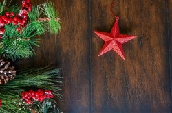 View of Lone and Festive Star on a String With Holiday Decorations on the Side