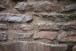 Close up of stone wall with cement. Texture of stonewall
