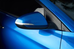 Side car mirror close-up. Details of blue car 