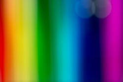 Rainbow abstract background and texture with soft blurred vertical stripes in the full colors of the spectrum in a vibrant pattern