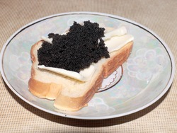 white wheat bread with butter and black sturgeon caviar as an exquisite sandwich