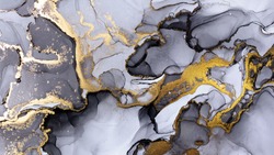 Closeup of black and shiny golden alcohol ink abstract texture, trendy wallpaper. Art for design project as background for invitation or greeting cards, flyer, poster, presentation, wrapping paper