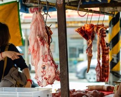 Fresh meat hanging at meat vendor in a Taiwan market