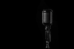 Vintage retro microphone isolated on black background