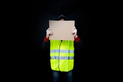Demonstrators in yellow vests with a cardboard blank sign, the protest of the population in France against the increase in the cost of fuel, excessive living expenses and high taxes, gilets jaunes 