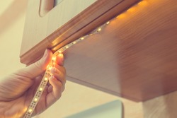How to install led strip for lighting correctly on the surface of the Cabinet on the kitchen set