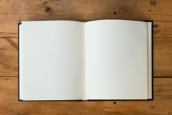 open book with blank pages on wood table
