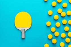 racket and many balls for table tennis on turquoise blue background. flat lay image of many table tennis balls and paddle. minimalist photo of yellow ping-pong equipment