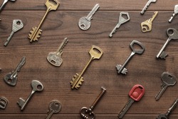 overhead of many different keys in oder on wooden background concept