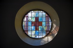 Picture of a colored church window with cross inside