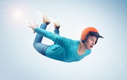 Crazy man in red helmet is flying in the sky. Jumper concept
