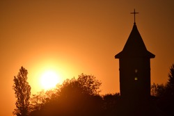 Silhouette of a christian church in sunset