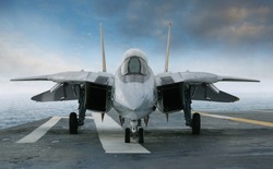 An F-14 jet fighter on an aircraft carrier deck beneath blue sky and clouds viewed from front