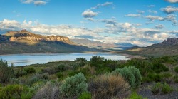 Panorama of the Absaroka Mountains of Wyoming above the Buffalo Bill Reservoir on a bright summer morning